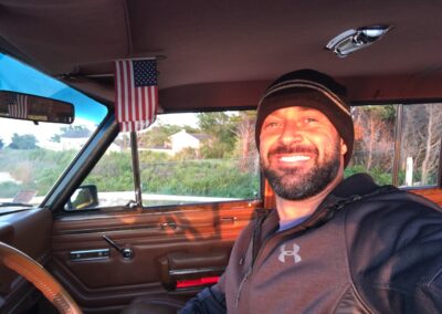 Man smiling from inside a Jeep