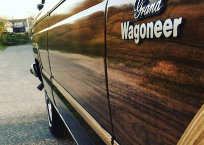 Closeup of a Grand Wagoneer badge on car