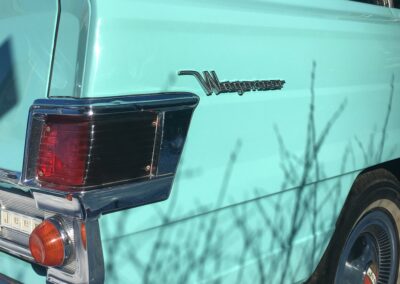 Closeup of tail light on a turquoise Jeep Kaiser