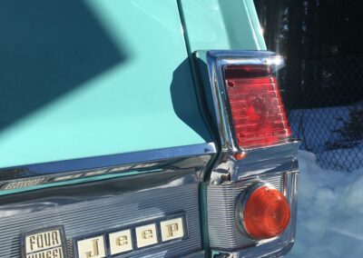 Rear and tail light of a turquoise classic Jeep