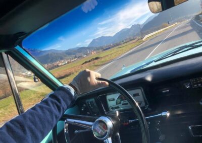 Man steering a turquoise jeep