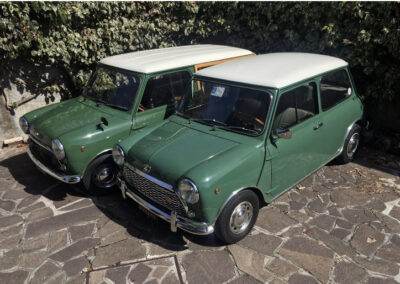 Two green MINIs parked side by side-Austin Mini-matic and the Mini-t