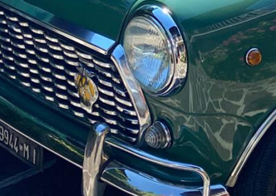 Closeup of a green Austin Mini-matic's front grill and chrome bumper