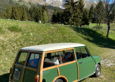 Green classic Mini Traveller parked on a mountain