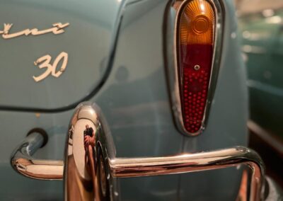Closeup of a tail light on a baby blue NSU Prinz car