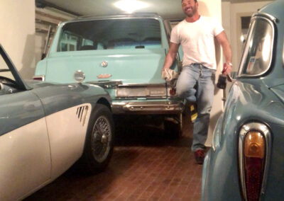 Man standing in classic car garage